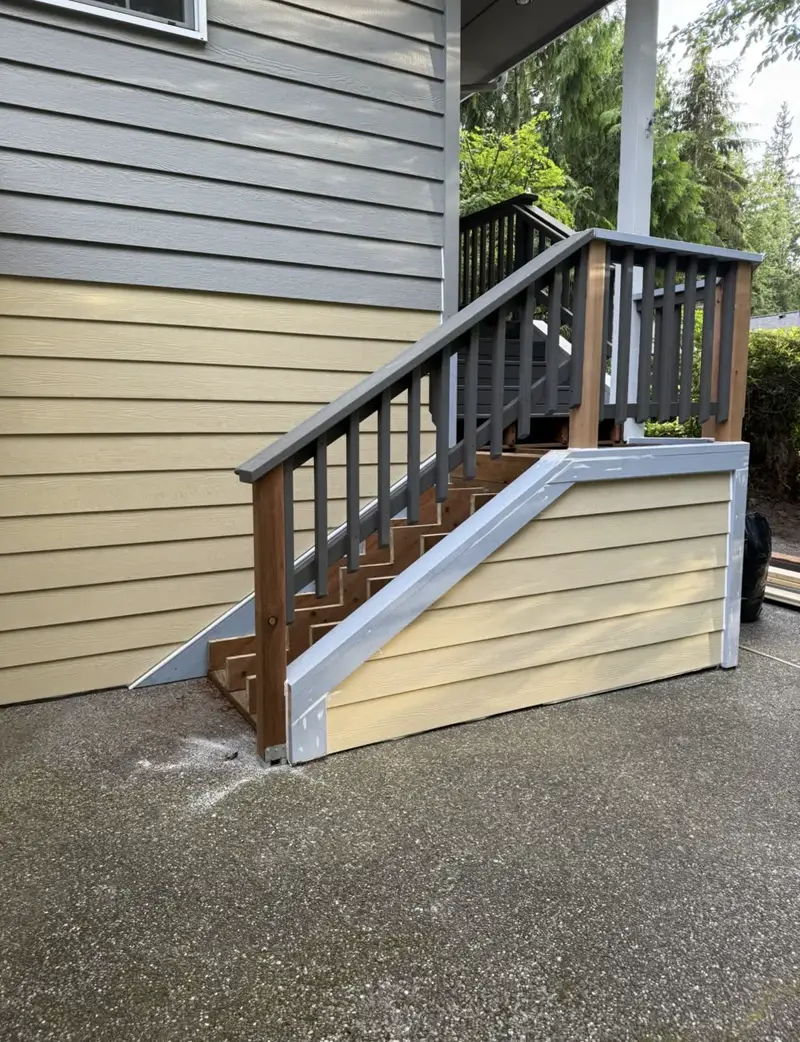 After: Rebuilt entry stairs with new railing and skirt