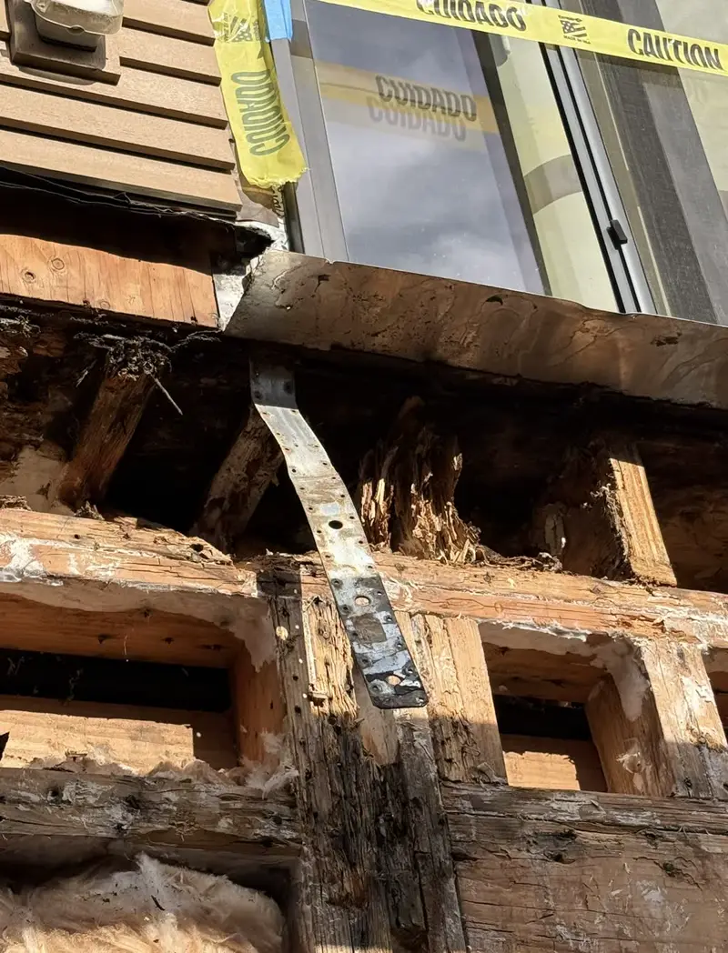 Before: Rotted balcony framing and wall